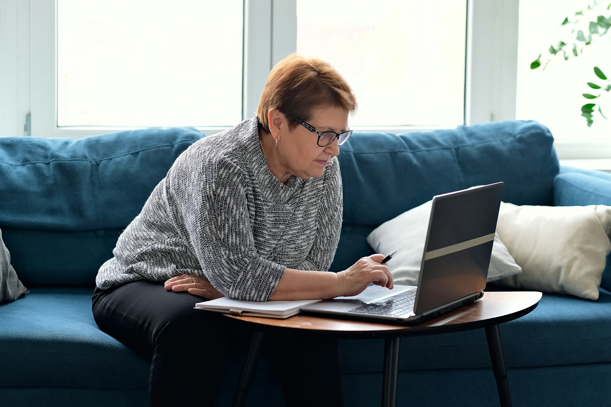 Senior woman using laptop for websurfing. The concept of senior employment, social security.